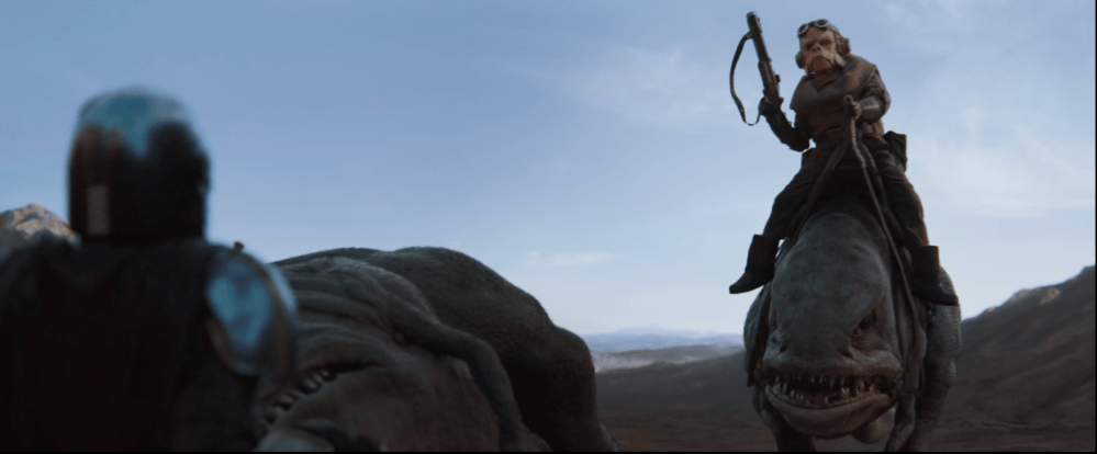 Kuuil coming up the Mandalorian after saving him from being attacked by the Bluurgs