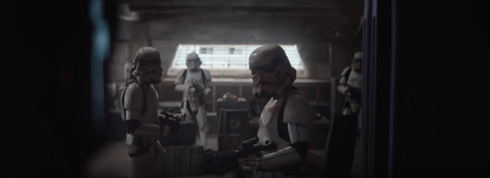 The Mandalorian walking into his meeting with Werner Herzog's character. He is accompanied with stormtroopers