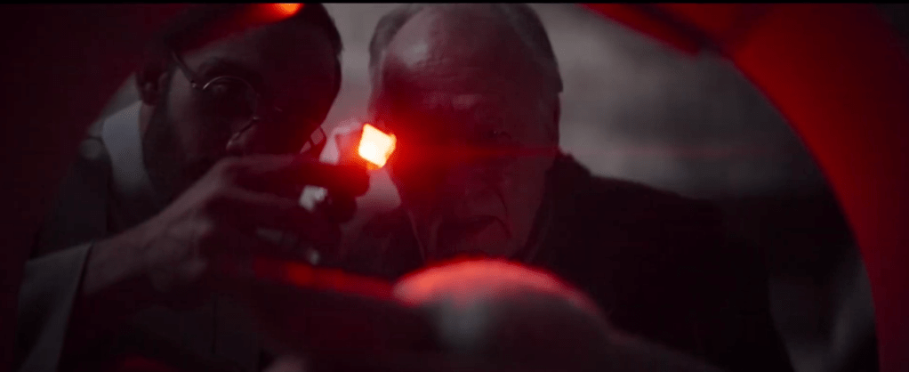 Dr. Pershing and the client looking at baby yoda and inspecting him.