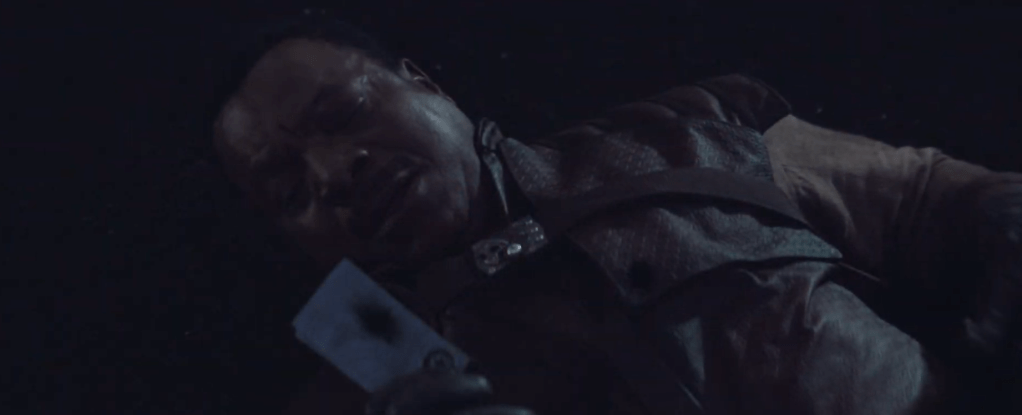 Carga on the ground holding the beskar that saved his life. 