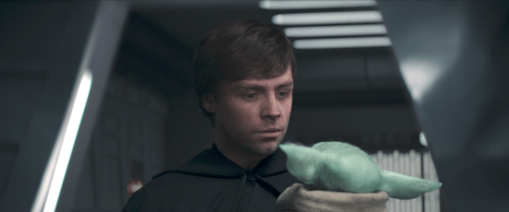 Luke Skywalker holding Grogu in The Mandalorians Season 2 finale. 